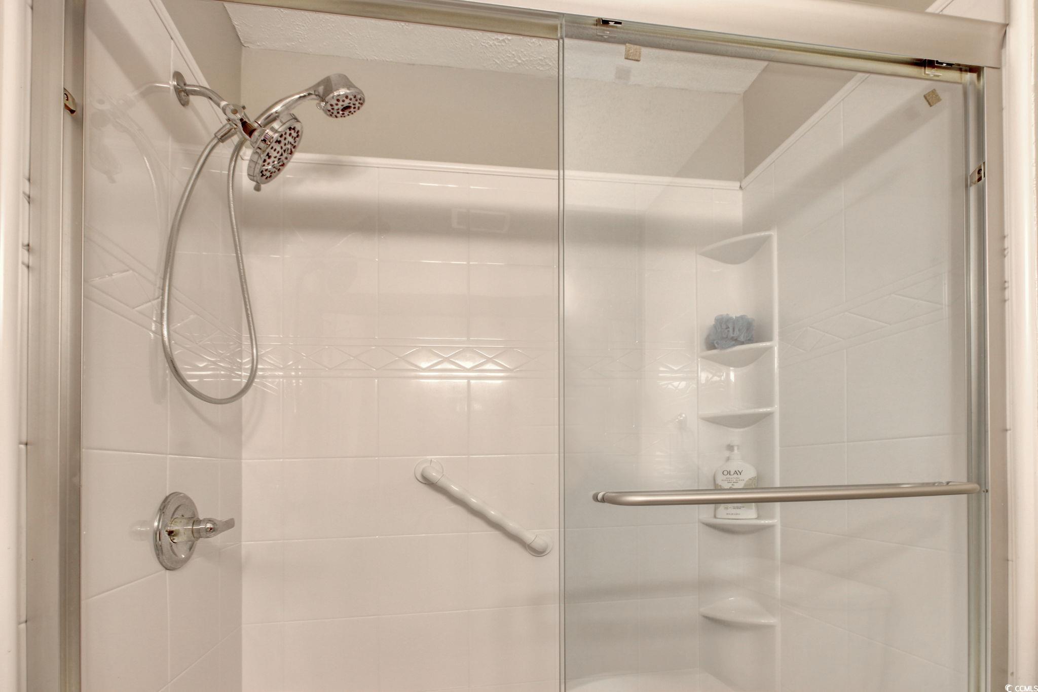 3931 Pinebrook Circle Little River, SC 29566 - Photo 27 of 32 Primary bathroom with shower and a vanity with solid surface countertop.