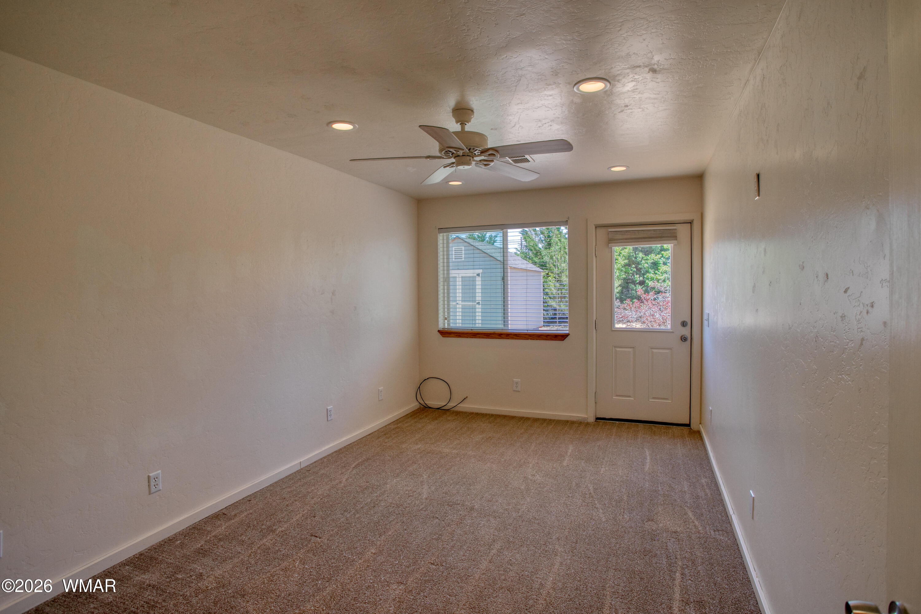 411 West Stratton Show Low, AZ 85901 - Photo 20 of 47 an empty room with a window and a ceiling fan