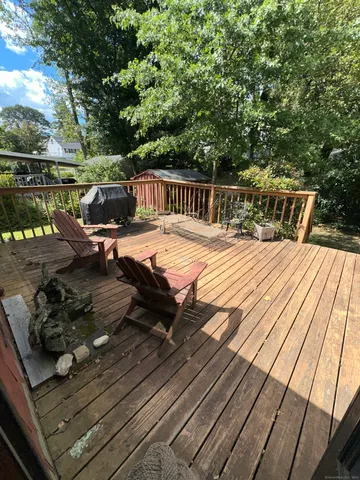 a view of a roof deck with wooden floor and barbeque oven