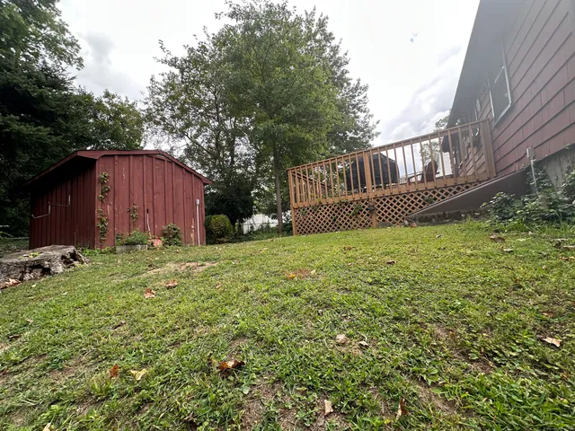 a view of a house with backyard and sitting area