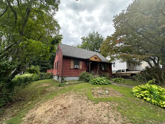 a view of backyard of house with green space