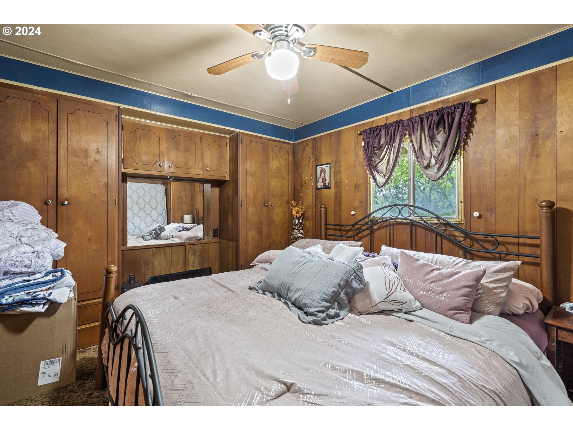 403 Azalea Drive Grants Pass, OR 97526 - Photo 7 of 17 a bedroom with a large bed and a chandelier