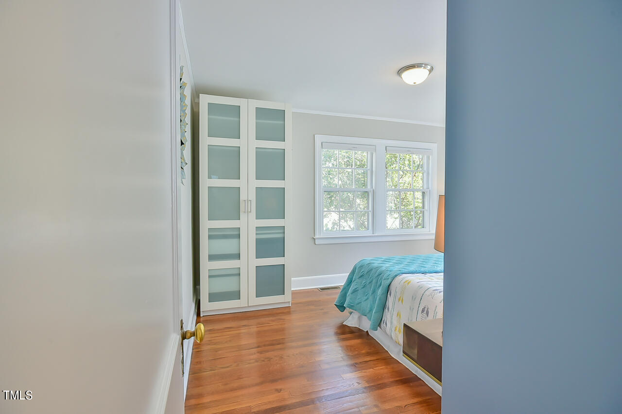2411 Farthing Street Durham, NC 27704 - Photo 14 of 47 a view of a bedroom with wooden floor and windows