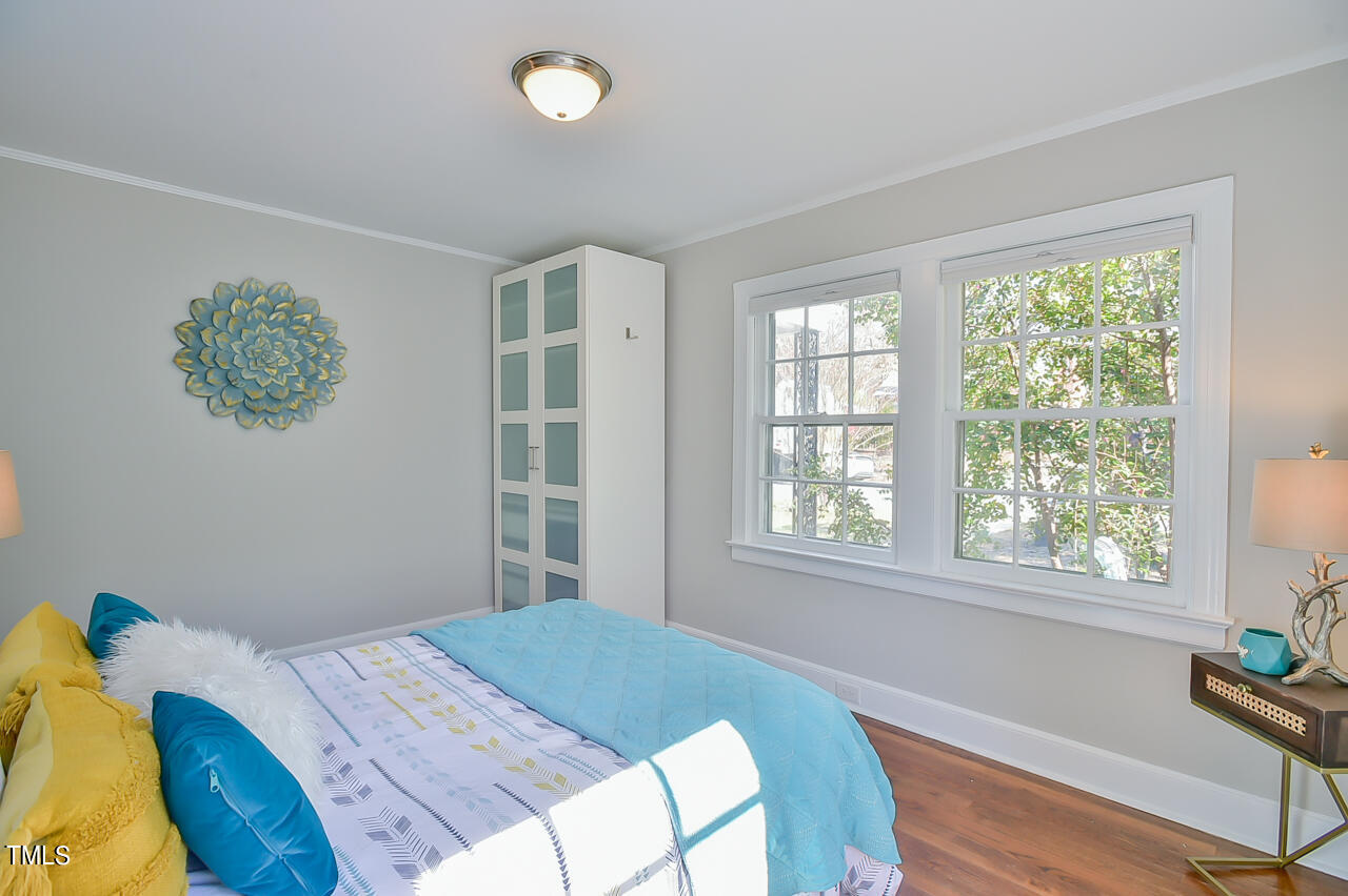 2411 Farthing Street Durham, NC 27704 - Photo 17 of 47 a bed sitting in a bedroom next to a window