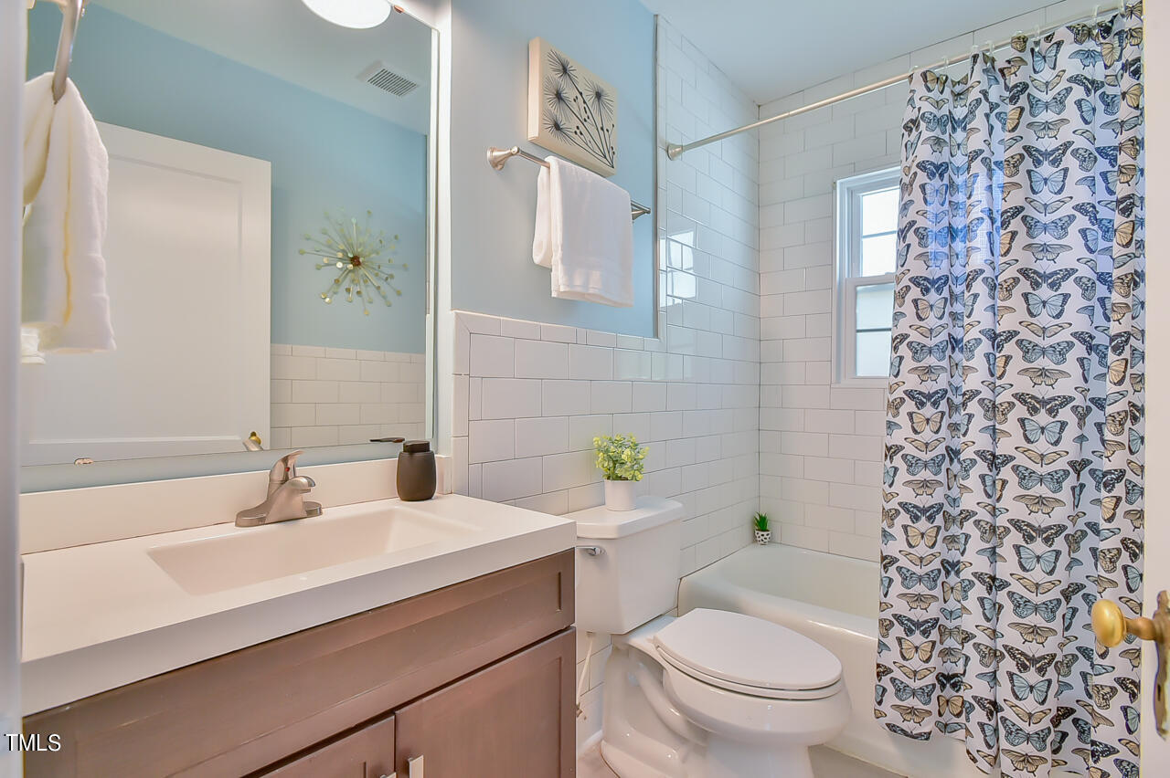 2411 Farthing Street Durham, NC 27704 - Photo 18 of 47 a bathroom with a sink toilet and shower