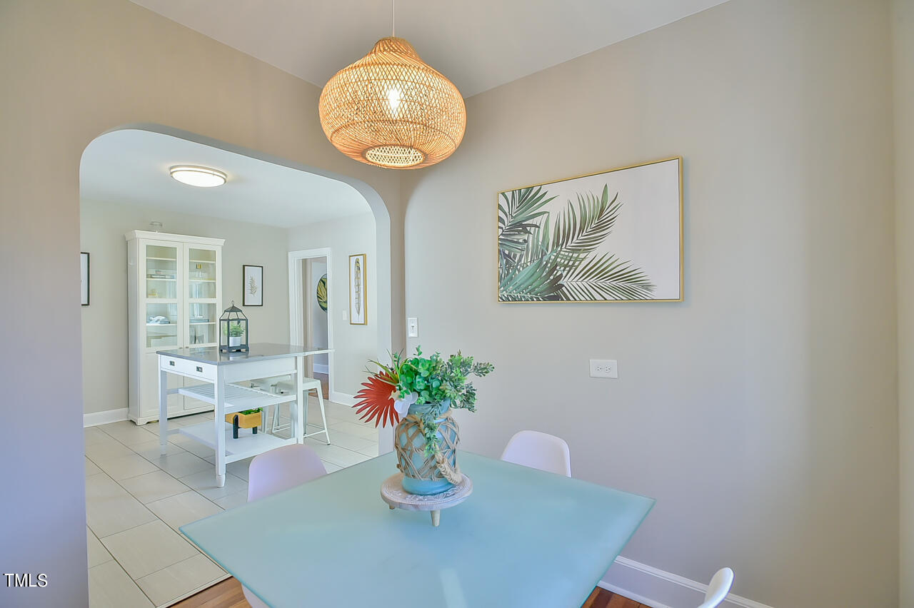 2411 Farthing Street Durham, NC 27704 - Photo 26 of 47 a view of a dining room with furniture and wooden floor
