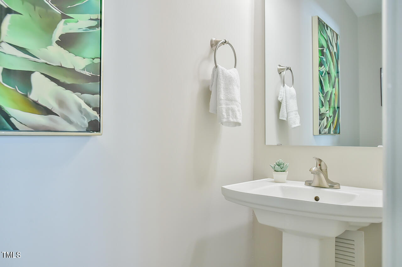2411 Farthing Street Durham, NC 27704 - Photo 30 of 47 a bathroom with a sink and a mirror