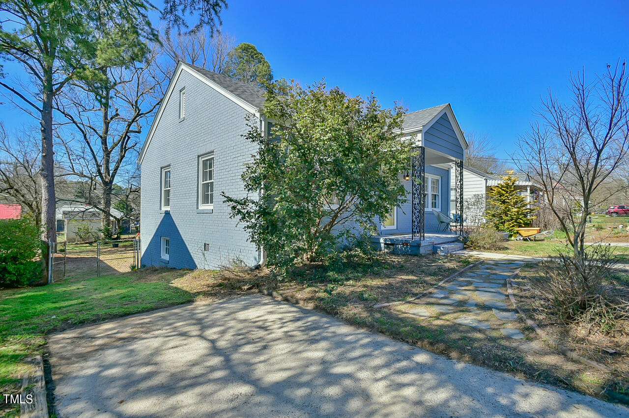 2411 Farthing Street Durham, NC 27704 - Photo 4 of 47 a view of a house with backyard and a tree