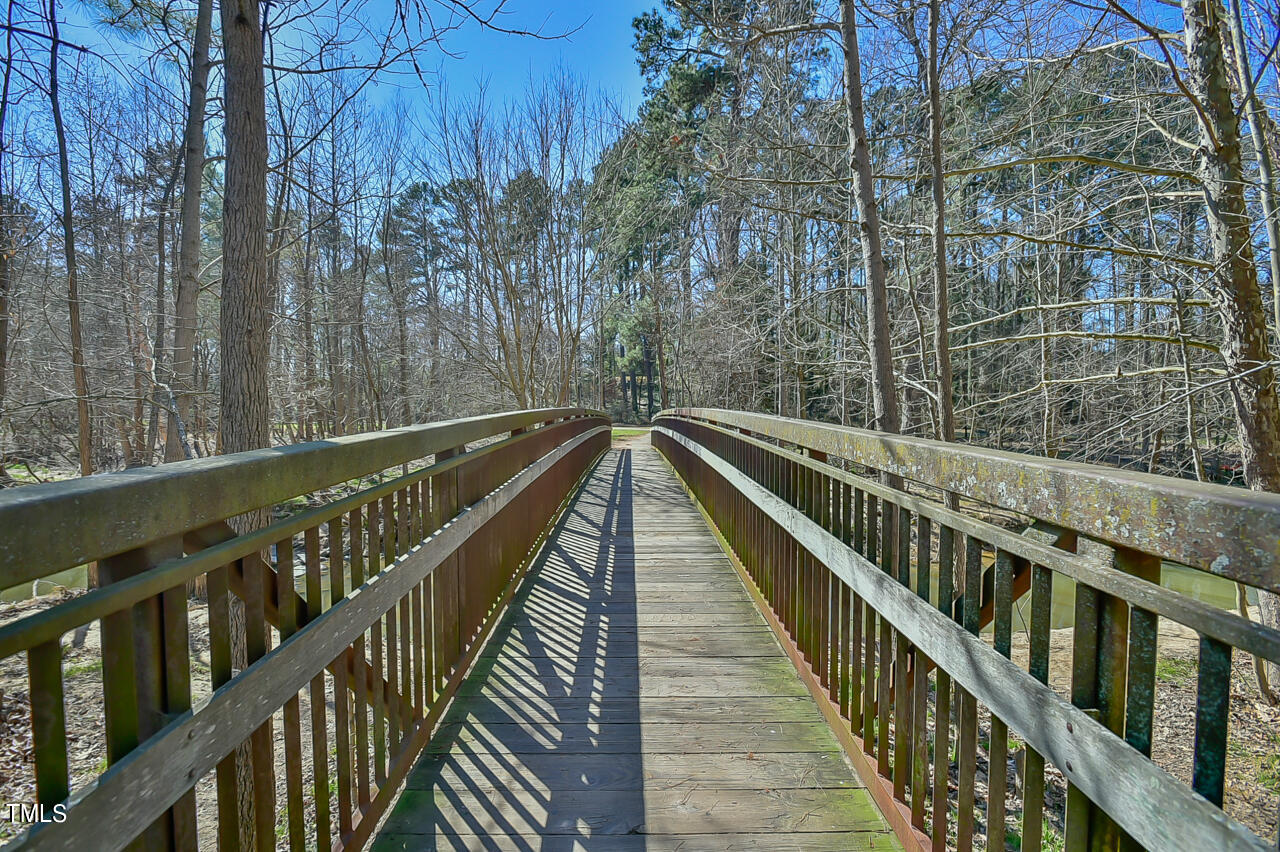 2411 Farthing Street Durham, NC 27704 - Photo 46 of 47 a view of balcony with wooden floor and trees