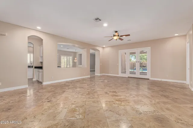 a view of an empty room with window and fireplace