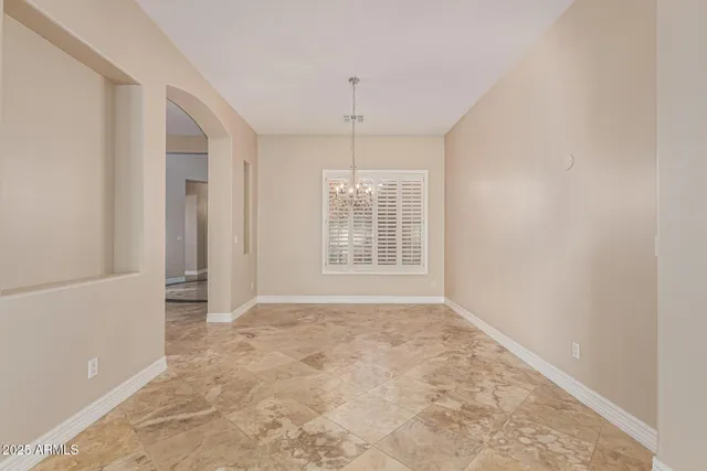 a kitchen with granite countertop white cabinets and window