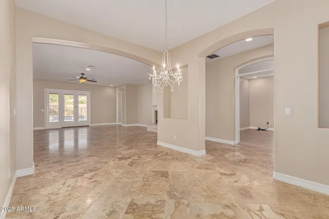 a large kitchen with granite countertop a sink and cabinets