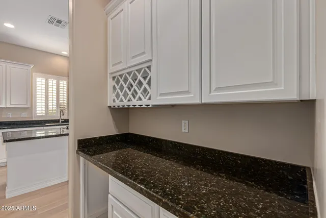 a kitchen with granite countertop a stove and a refrigerator