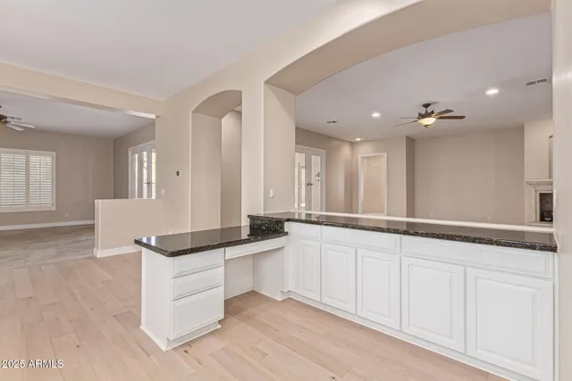 a view of an empty room with a ceiling fan