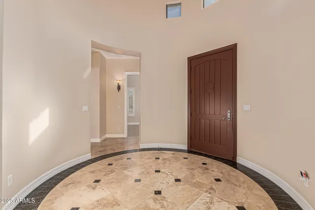 an empty room with wooden floor and mirror