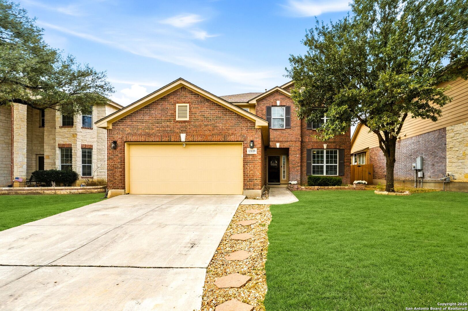 13119 Moselle Forest Helotes, TX 78023 - Photo 2 of 38 a front view of a house with a yard and garage