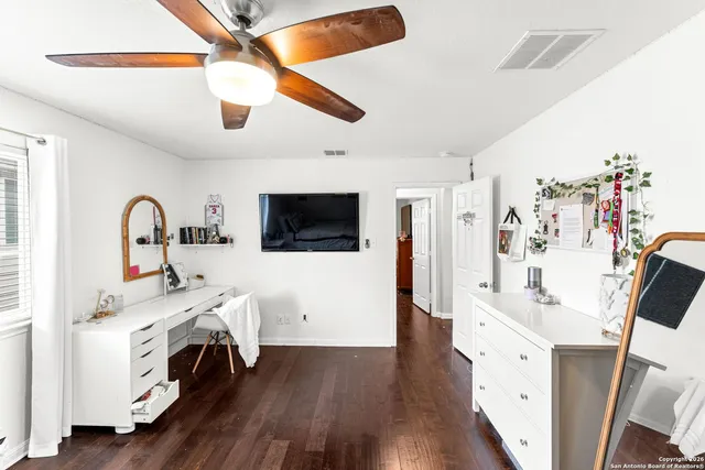 a view of a workspace with furniture and a window