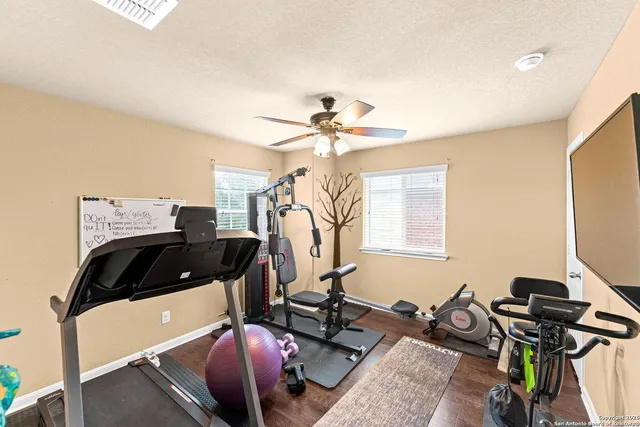 a bathroom with a sink mirror and shower