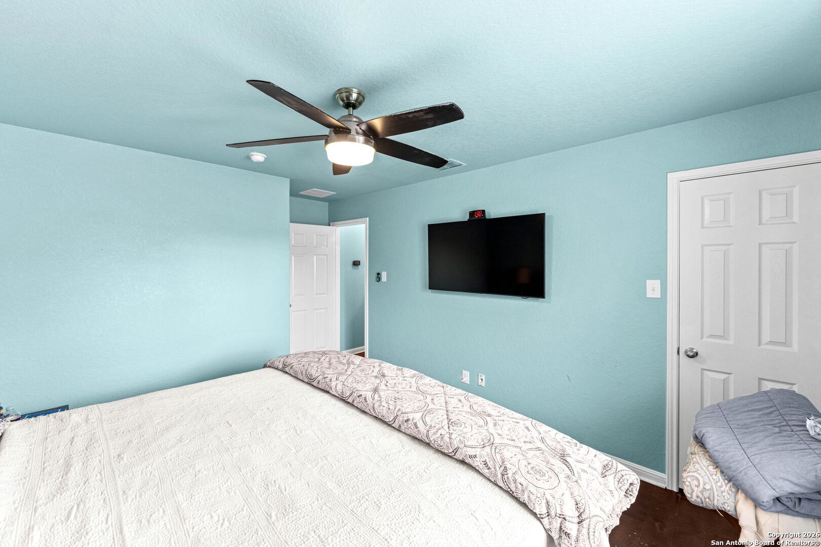 13119 Moselle Forest Helotes, TX 78023 - Photo 33 of 38 a bedroom with a large bed and a flat screen tv