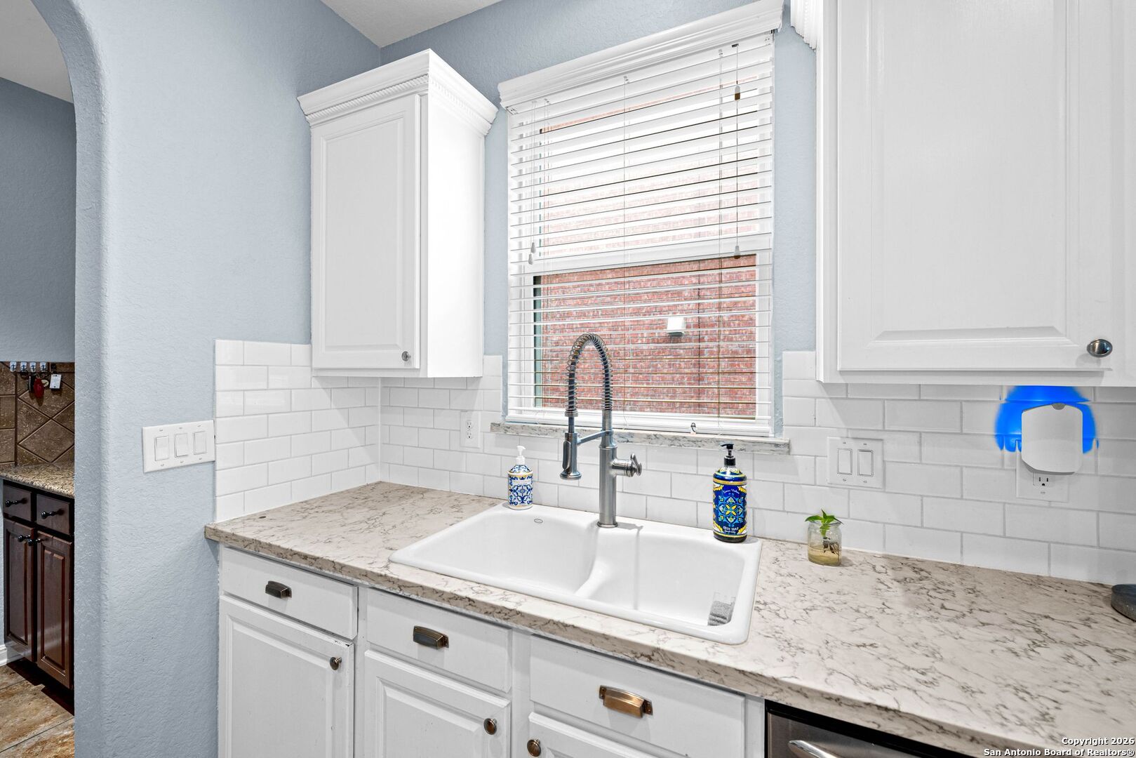 13119 Moselle Forest Helotes, TX 78023 - Photo 10 of 38 a kitchen with granite countertop a sink and a white wooden cabinets