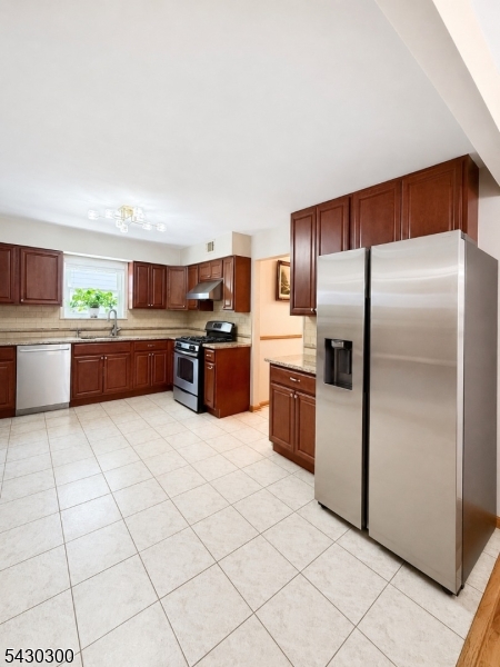 25 Spring Street, Unit A Millburn, NJ 07041 - Photo 4 of 21 a large kitchen with stainless steel appliances granite countertop a refrigerator and a stove