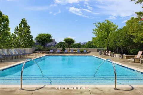 a view of a swimming pool with a lounge chairs