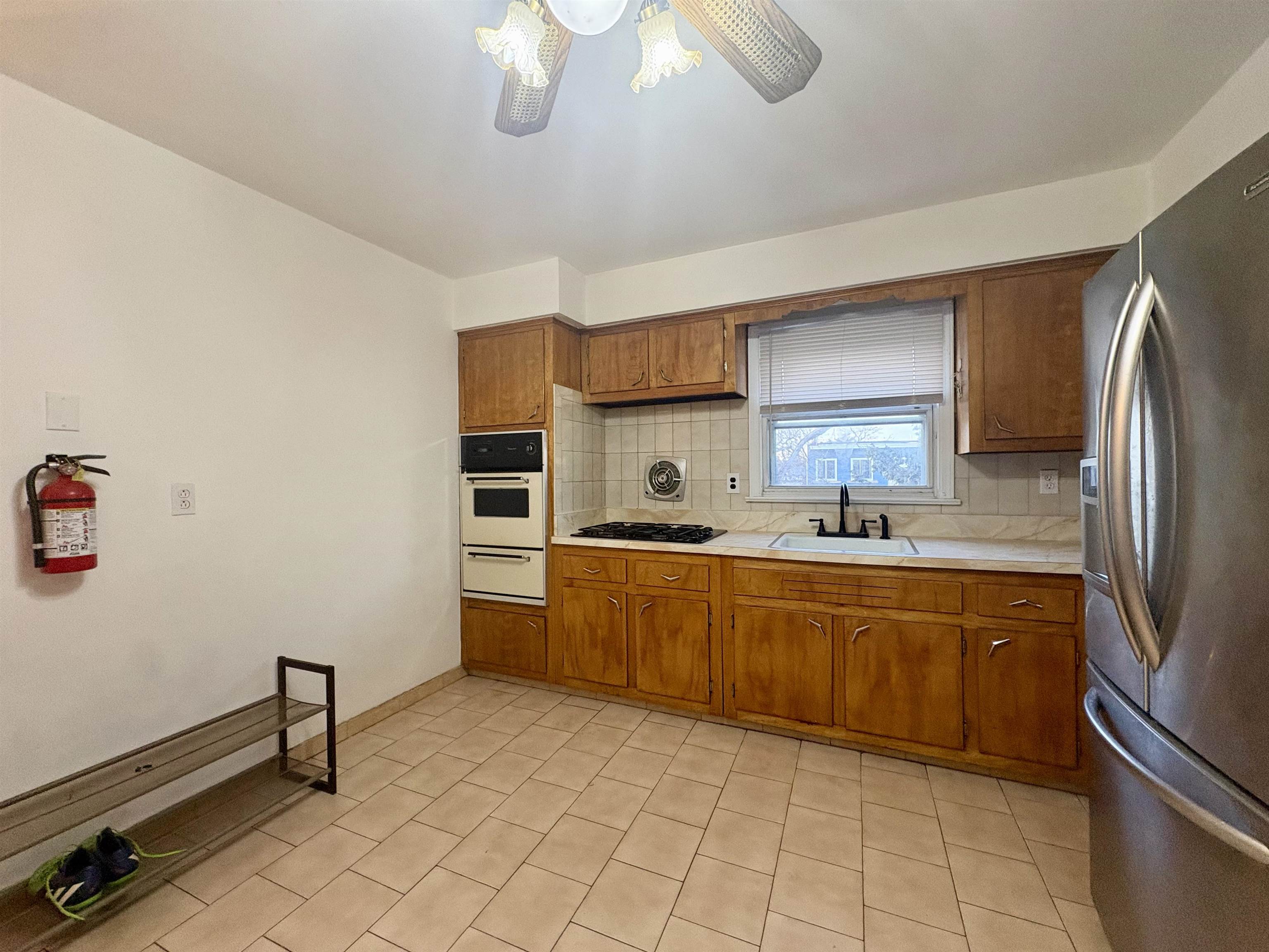 30 Kennedy Street, Unit 2 Hackensack, NJ 07601 - Photo 10 of 11 a kitchen with cabinets and stainless steel appliances
