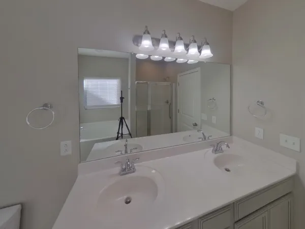 a bathroom with a sink a large mirror and a shower