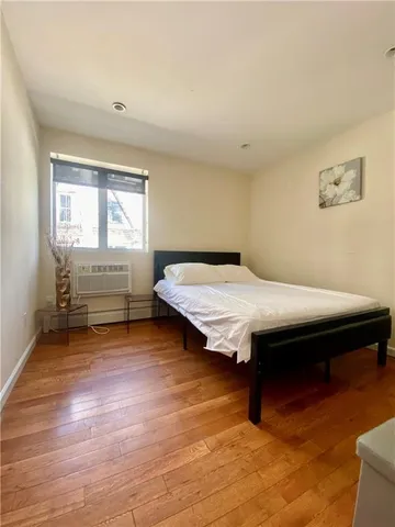 a bedroom with a bed and window