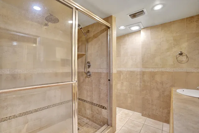 a bathroom with a shower and a glass door