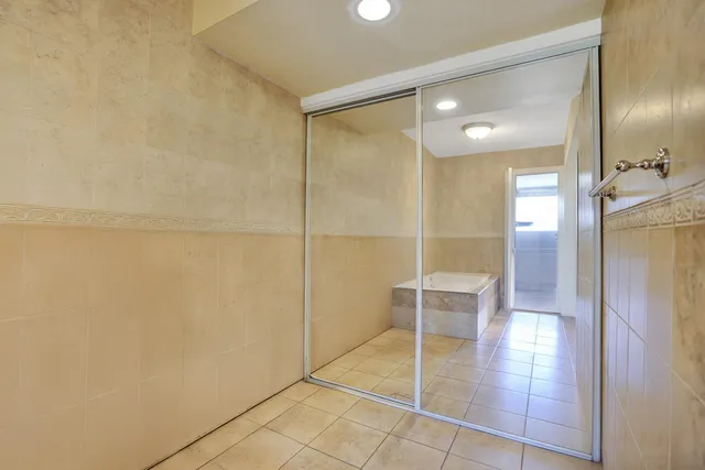 a bathroom with a shower and a glass door