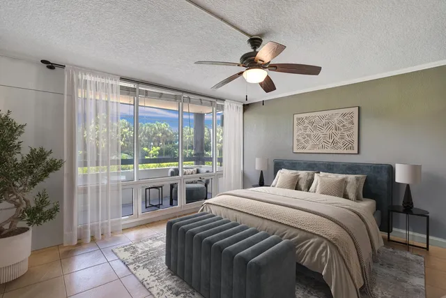 a bedroom with a large bed and a large window