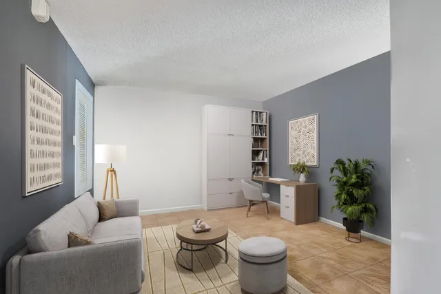 a living room with furniture and a potted plant
