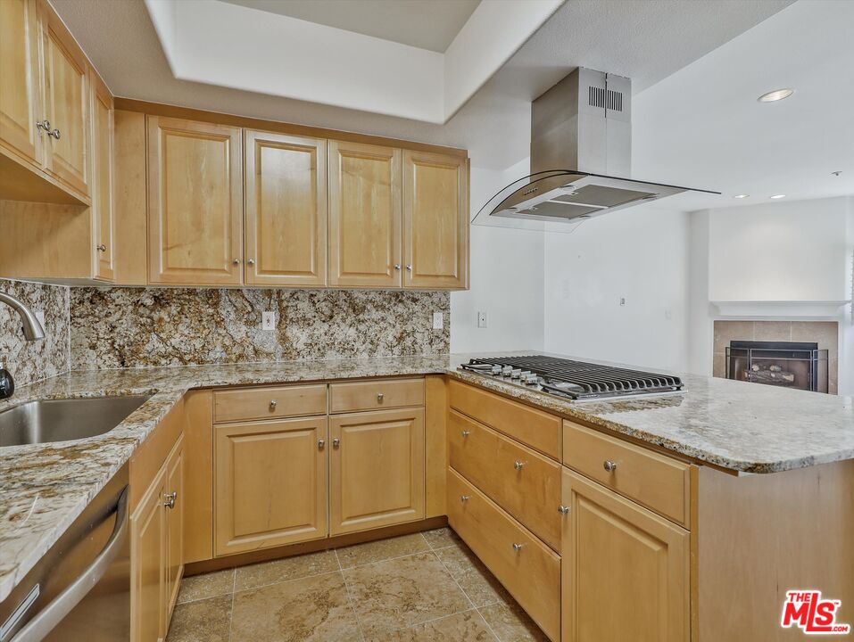937 12th Street, Unit 308 Santa Monica, CA 90403 - Photo 14 of 39 a kitchen with granite countertop a sink stove and cabinets