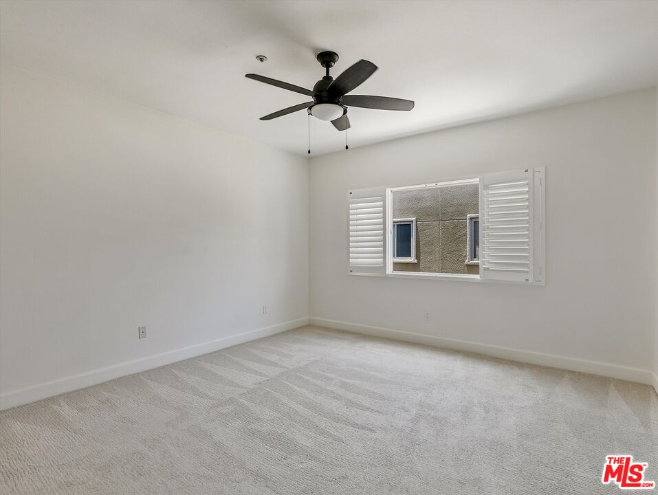 937 12th Street, Unit 308 Santa Monica, CA 90403 - Photo 20 of 39 a view of a livingroom with a ceiling fan and window