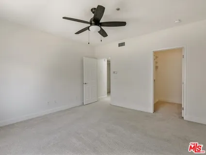 a view of a room with a ceiling fan