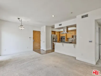a view of a room with window and hardwood