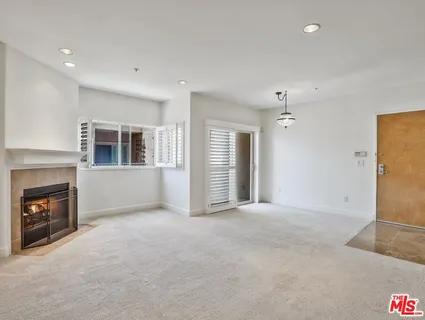 a view of an empty room with a fireplace
