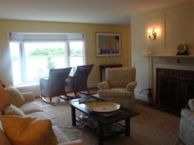55 Strong Island Road Chatham, MA 02633 - Photo 7 of 16 a living room with furniture and a fireplace
