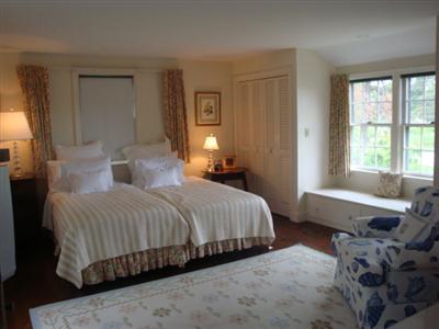55 Strong Island Road Chatham, MA 02633 - Photo 10 of 16 a bedroom with a bed a table and windows