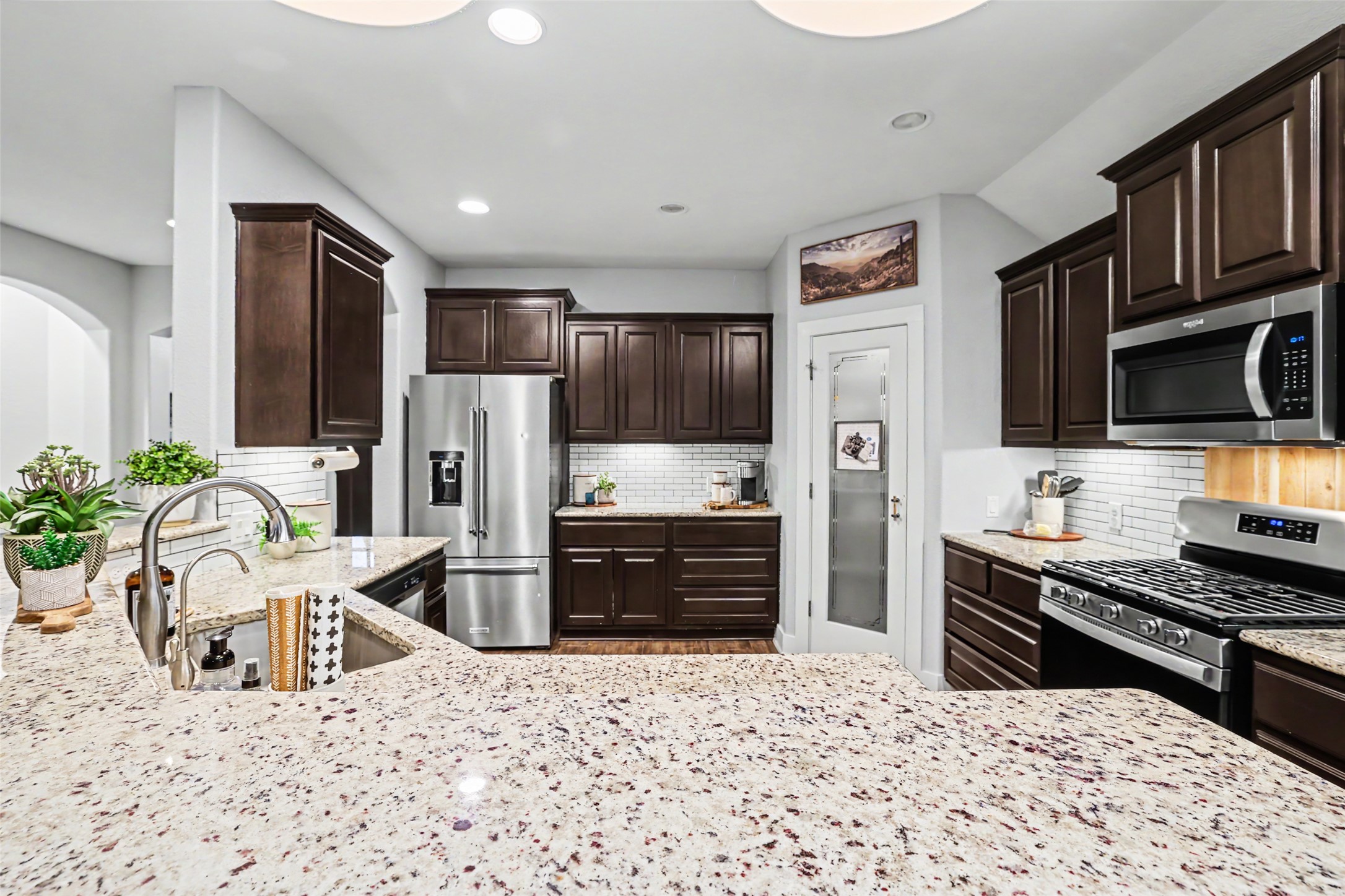 117 Rock Dock Road Georgetown, TX 78633 - Photo 12 of 38 a kitchen with stainless steel appliances kitchen island granite countertop a refrigerator and a stove top oven