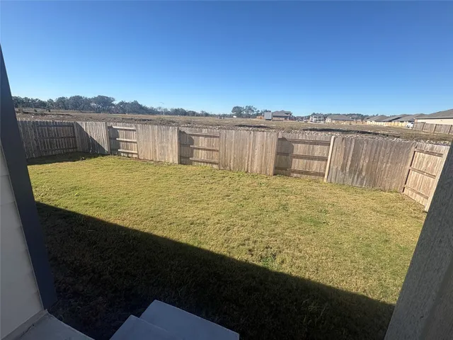 a view of a swimming pool with a yard