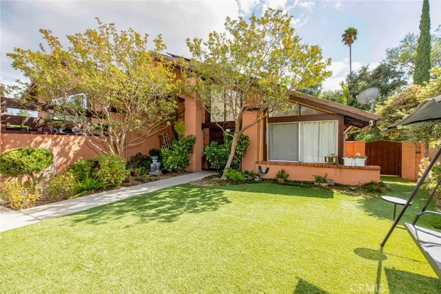 a living room with furniture a fireplace and a large window