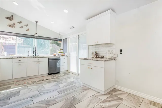 a bathroom with a sink a toilet a shower and a mirror