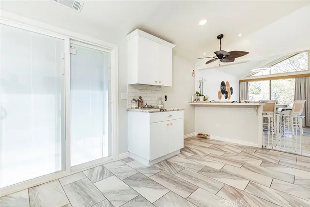 a view of entryway with paintings on the wall