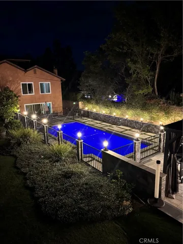 an aerial view of a house with a swimming pool