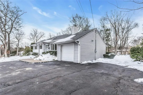 a view of a house with a yard and garage