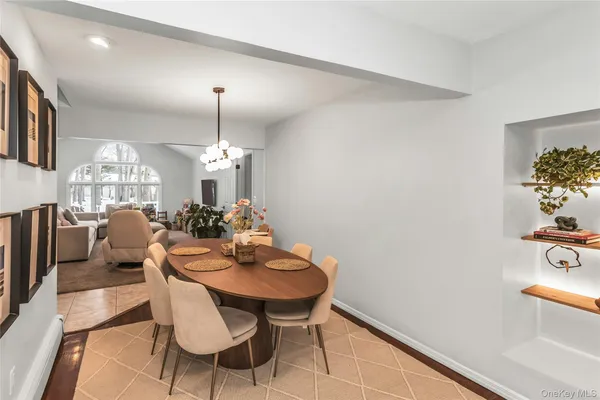a view of a dining room with furniture and chandelier