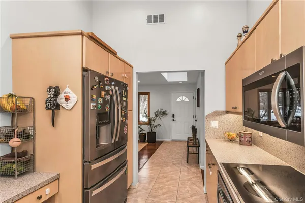 a kitchen with a refrigerator and a stove