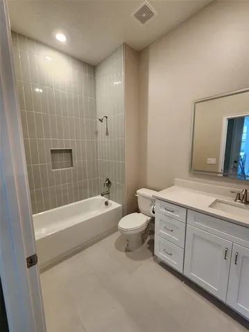 a bathroom with a tub sink toilet and a mirror